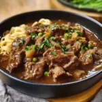 Delicious bowl of hearty beef stew with vegetables and herbs