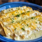 Delicious sour cream chicken enchiladas topped with cheese and spices