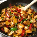 Colorful chicken stir fry with vegetables in a skillet