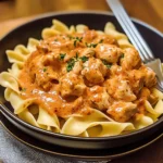 Delicious Chicken Paprikash served over buttered egg noodles.