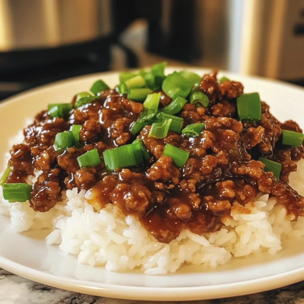 Delicious plate of Mongolian Ground Beef served with rice and green onions